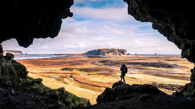 Girl taking photo across landscape