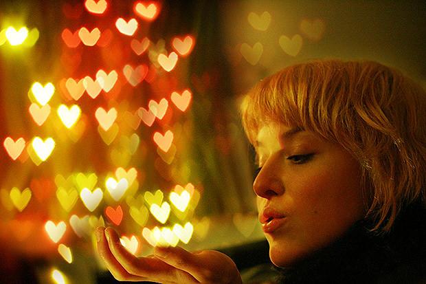 Woman in front of heart shaped bokeh