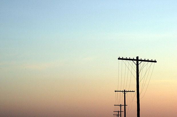 The sky forming negative space around power lines