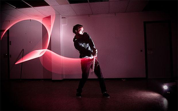 Slow sync flash photo of a man waving a light around