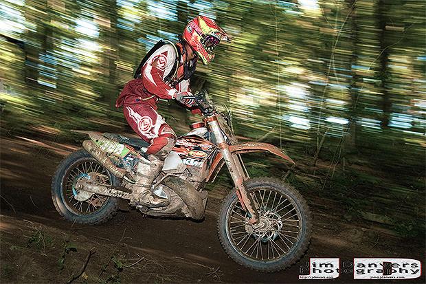 A motocross rider with motion blur in the background